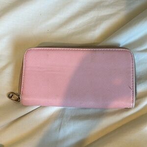 Pink wallet with gold emblem